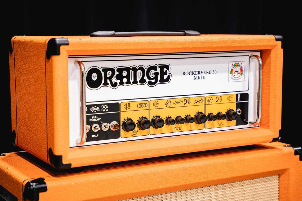 Orange amp head on a cabinet